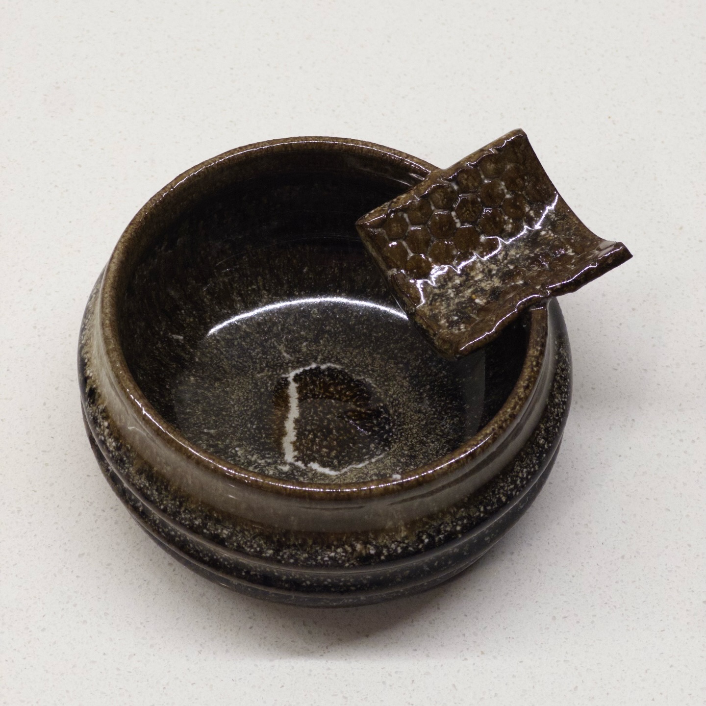 Ribbed incense holder with honeycomb tab, earth and iron glaze