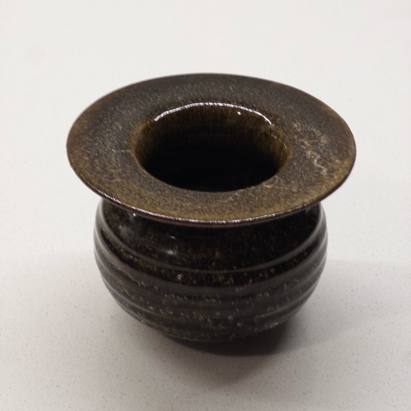 Bellied incense holder with flared rim, dark olive glaze